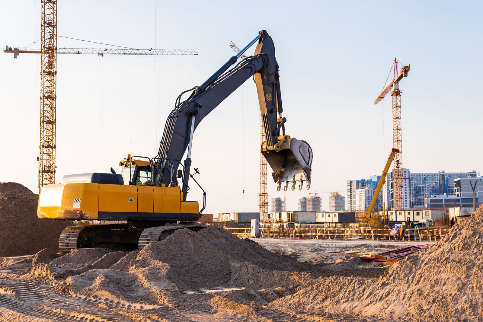 Yellow excavator working on an earthworks site