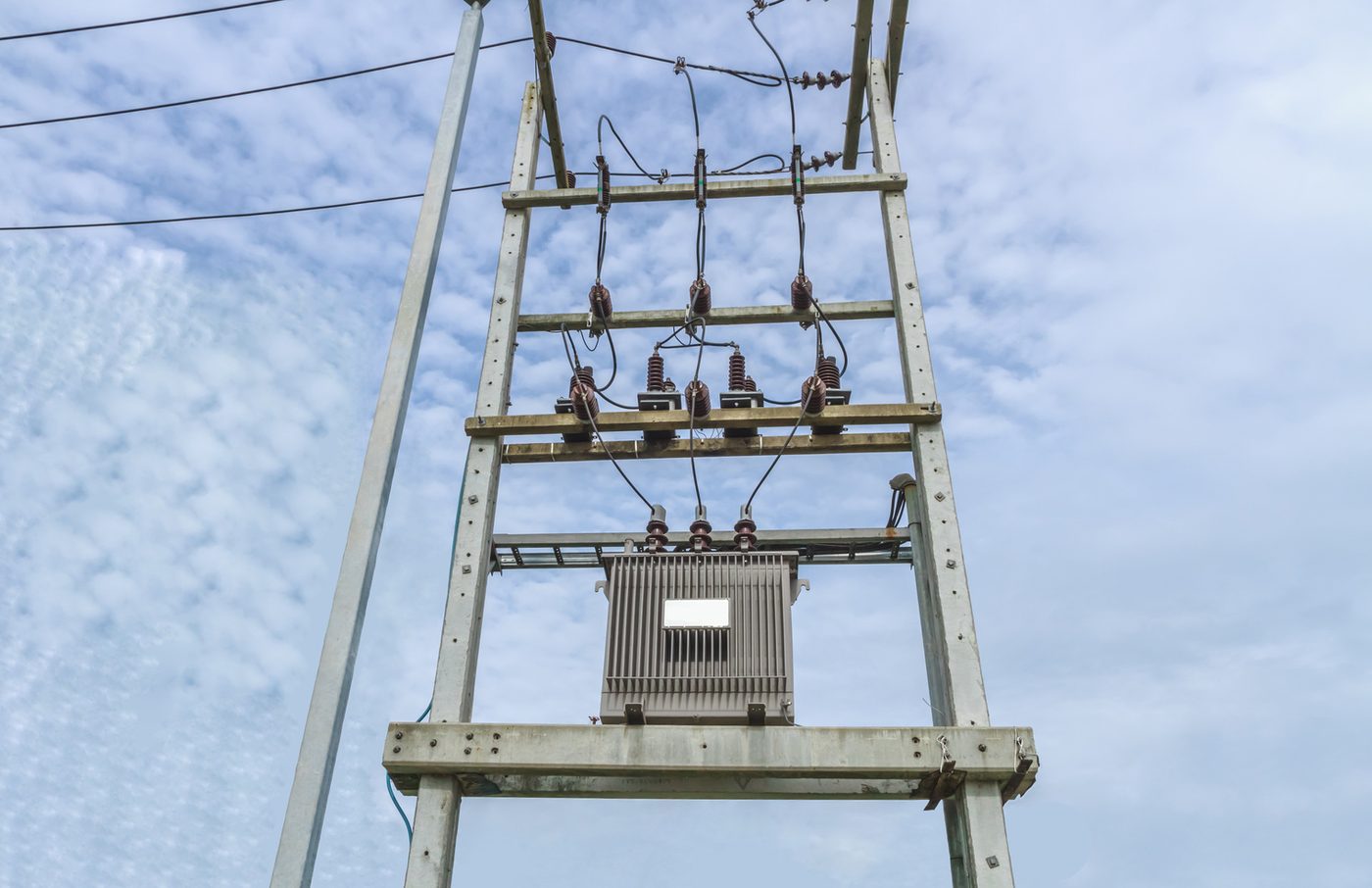 Pole-mounted transformer on a concrete pole structure